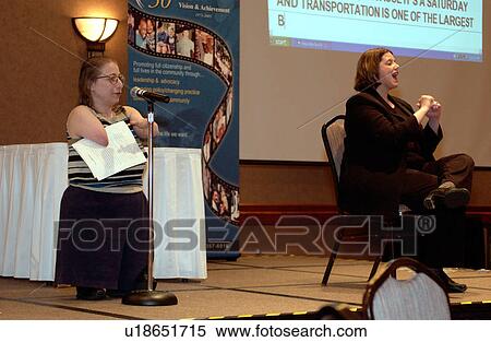 Person with disabilities speaking to a group of people at a disability activist conference - while an interpreter and real time captioning capture her message. View Large Photo Image Stock Photography - Person with disabilities speaking to a group of people at a disability activist conference - while an interpreter and real time captioning capture her message.. Fotosearch