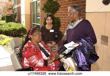 Three women talking and comparing notes during break at a Disability Action Conference. View Large Photo Image Stock Photograph - Three women talking and comparing notes during break at a Disability Action Conference.. Fotosearch