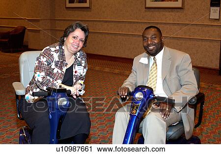 Two people with disabilities talking at a conference, breaking for a moment to pose for a picture at a disability conference. View Large Photo Image Stock Image - Two people with disabilities talking at a conference, breaking for a moment to pose for a picture at a disability conference.. Fotosearch