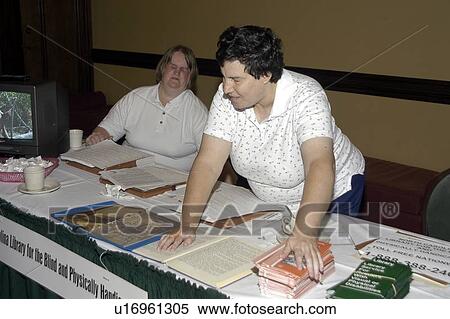 Two women with visual impairments/blindness ômanningö a display booth at a conference. View Large Photo Image Stock Photography - Two women with visual impairments/blindness ômanningö a display booth at a conference.. Fotosearch