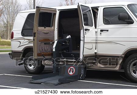 Stock Image - Van equipped with a lift -- allowing people with mobility impairments to attend conferences and meetings.. Fotosearch