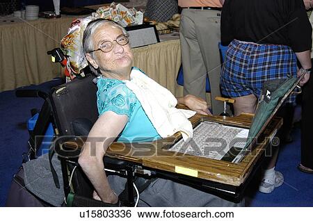 Stock Photograph - Woman in wheelchair with computer.. Fotosearch