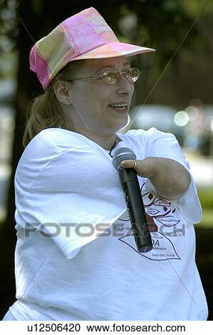 Woman using a microphone. View Large Photo Image Stock Image - Woman using a microphone.. Fotosearch