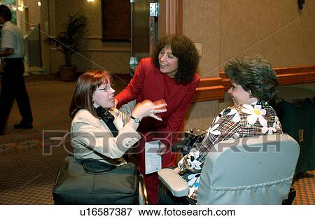 Women with disabilities talking and laughing together as they meet at a conference. View Large Photo Image Stock Photo - Women with disabilities talking and laughing together as they meet at a conference.. Fotosearch