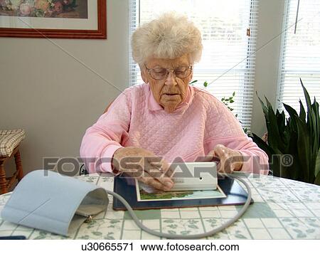 An elderly woman reviews a reading after taking her blood pressure. View Large Photo Image Stock Image - An elderly woman reviews a reading after taking her blood pressure.. Fotosearch