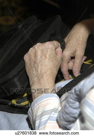 Close up picture of a womanÆs hands resting in her lap, clenched with spasticity. View Large Photo Image Stock Photo - Close up picture of a womanÆs hands resting in her lap, clenched with spasticity.. Fotosearch