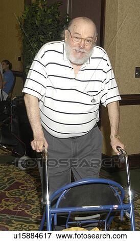 Older man with physical disabilities utilizing a walker for mobility assistance. View Large Photo Image Stock Photo - Older man with physical disabilities utilizing a walker for mobility assistance.. Fotosearch