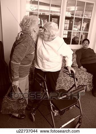 Two elderly sisters hug good bye after a nice visit. View Large Photo Image Picture - Two elderly sisters hug good bye after a nice visit.. Fotosearch