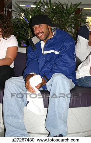 An African American man with cognitive disabilities sitting on a public bench, resting among the other shoppers at a mall. View Large Photo Image Stock Image - An African American man with cognitive disabilities sitting on a public bench, resting among the other shoppers at a mall.. Fotosearch