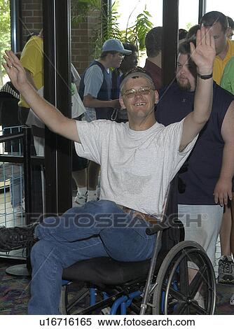 Man with a disability, utilizing a wheelchair for mobility, entering a theater. View Large Photo Image Stock Photography - Man with a disability, utilizing a wheelchair for mobility, entering a theater.. Fotosearch