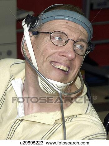 Man with significant disabilities utilizing headgear to operate communications apparatus. View Large Photo Image Stock Image - Man with significant disabilities utilizing headgear to operate communications apparatus.. Fotosearch