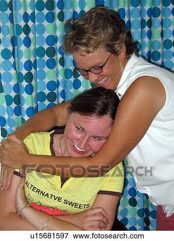 Mother and daughter (person with muscular dystrophy) share a hug and a laugh. View Large Photo Image Stock Photo - Mother and daughter (person with muscular dystrophy) share a hug and a laugh.. Fotosearch