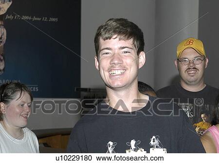Smiling face of a man with disabilities with his friends. View Large Photo Image Stock Image - Smiling face of a man with disabilities with his friends.. Fotosearch