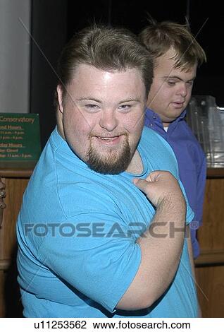 Smiling face of a man with disabilities with his friends. View Large Photo Image Stock Image - Smiling face of a man with disabilities with his friends.. Fotosearch