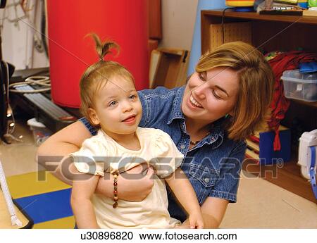 Beautiful little girl with disabilities in being supported by her physical therapist after a session. View Large Photo Image Stock Image - Beautiful little girl with disabilities in being supported by her physical therapist after a session.. Fotosearch