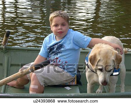 Boy, with Muscular Dystrophy, with his service dog, in a row boat. View Large Photo Image Stock Photo - Boy, with Muscular Dystrophy, with his service dog, in a row boat.. Fotosearch