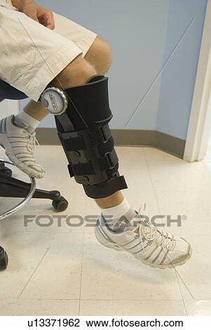 Close up shot of a man's leg with a black brace on it. View Large Photo Image Stock Image - Close up shot of a man's leg with a black brace on it.. Fotosearch