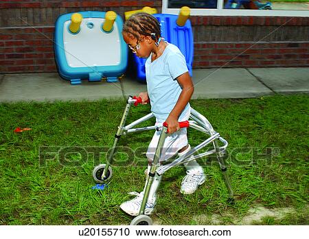 Cute little girl with a disability making her way across the playground with the assistance of a walker. View Large Photo Image Stock Image - Cute little girl with a disability making her way across the playground with the assistance of a walker.. Fotosearch