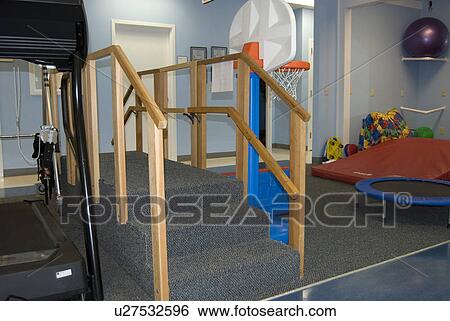 Steps, basketball goal, treadmill, and other items in a physical therapist's office. View Large Photo Image Stock Photograph - Steps, basketball goal, treadmill, and other items in a physical therapist's office. . Fotosearch