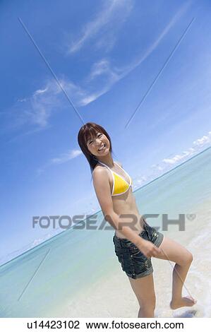 Portrait of a young woman walking on beach, smiling, Saipan, USA View Large Photo Image Stock Image - Portrait of a young woman walking on beach, smiling, Saipan, USA . Fotosearch