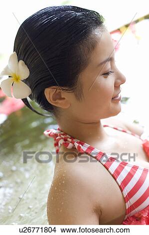 Young woman in a bath full of flowers, Saipan View Large Photo Image Picture - Young woman in a bath full of flowers, Saipan. Fotosearch