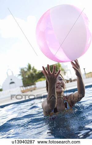 Stock Photo - Young woman in a bikini in swimming pool, Saipan. Fotosearch