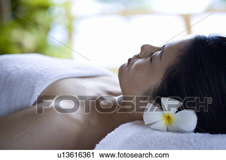 Stock Image - Young woman lying on a massage table . Fotosearch