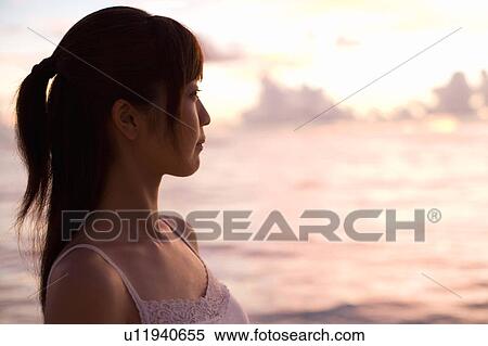 Young woman on beach in the evening, differential focus, Saipan, USA View Large Photo Image Stock Photography - Young woman on beach in the evening, differential focus, Saipan, USA . Fotosearch