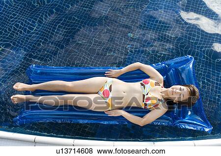Young woman relaxing on a pool raft, Saipan View Large Photo Image Stock Photo - Young woman relaxing on a pool raft, Saipan. Fotosearch