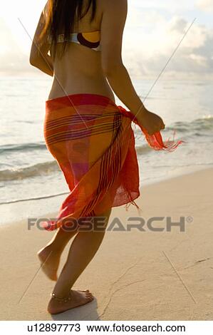 Young woman running on beach, Saipan, USA View Large Photo Image Stock Image - Young woman running on beach, Saipan, USA . Fotosearch
