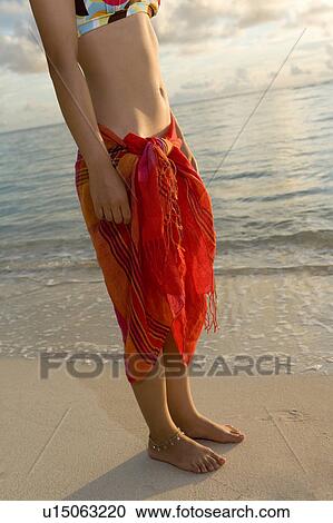 Young woman standing on beach, Saipan, USA View Large Photo Image Stock Image - Young woman standing on beach, Saipan, USA . Fotosearch