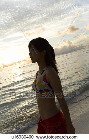 Young woman standing on beach, Saipan, USA View Large Photo Image Stock Image - Young woman standing on beach, Saipan, USA . Fotosearch