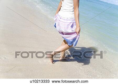 Young woman walking on beach, Saipan, USA View Large Photo Image Stock Image - Young woman walking on beach, Saipan, USA . Fotosearch