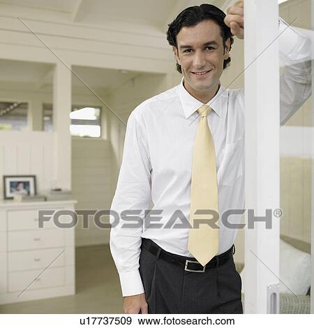 Stock Photo - Businessman by door (portrait). Fotosearch