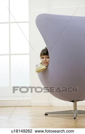 Stock Image - Girl sitting on chair (portrait). Fotosearch