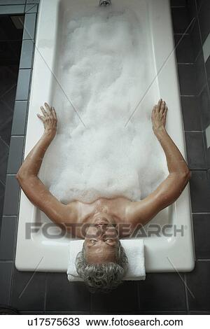Stock Image - Mature Woman Having Bath. Fotosearch