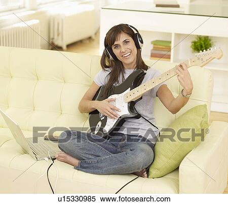 Mid-Adult Woman Playing Electric Guitar View Large Photo Image Stock Photography - Mid-Adult Woman Playing Electric Guitar. Fotosearch