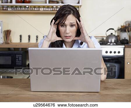Worried Mid-Adult Woman Using Laptop View Large Photo Image Stock Photograph - Worried Mid-Adult Woman Using Laptop. Fotosearch