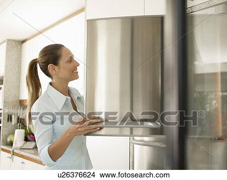Young woman at freezer View Large Photo Image Picture - Young woman at freezer. Fotosearch