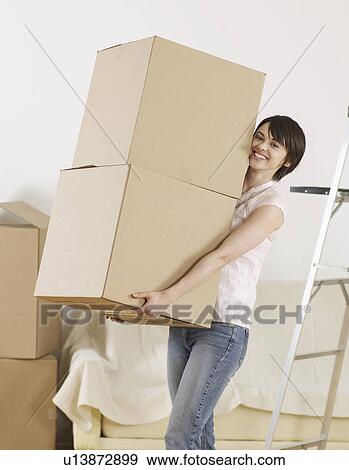Young Woman Carrying Two Cardboard Boxes View Large Photo Image Stock Photo - Young Woman Carrying Two Cardboard Boxes. Fotosearch