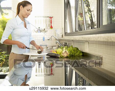 Young woman chopping eggplant View Large Photo Image Stock Image - Young woman chopping eggplant. Fotosearch