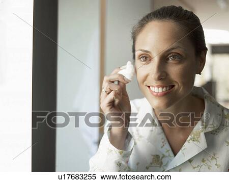 Young woman cleaning face View Large Photo Image Stock Photography - Young woman cleaning face. Fotosearch