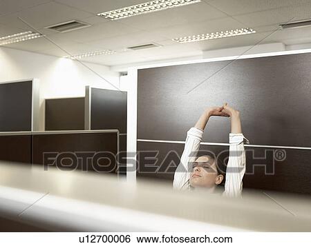 Female office worker stretching View Large Photo Image Stock Photograph - Female office worker stretching. Fotosearch