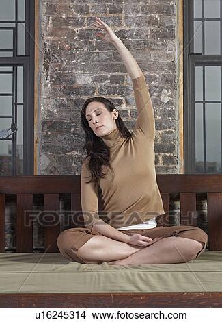 Picture - Mid-Adult Woman Stretching. Fotosearch