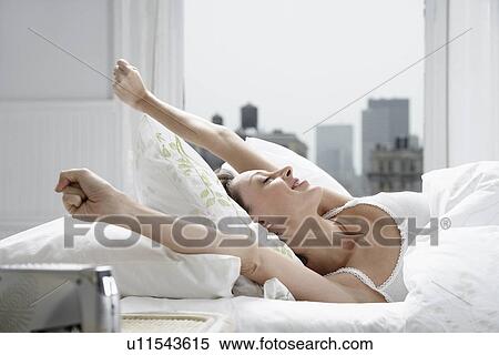 Mid adult woman waking up View Large Photo Image Stock Photography - Mid adult woman waking up. Fotosearch