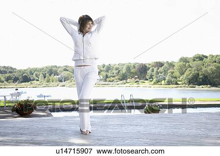 Woman stretching near pool View Large Photo Image Stock Photo - Woman stretching near pool. Fotosearch