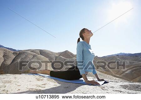 Young woman stretching in desert View Large Photo Image Stock Photography - Young woman stretching in desert. Fotosearch