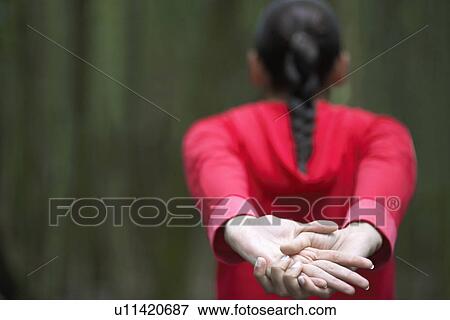 Stock Photo - Young woman stretching, rear view. Fotosearch