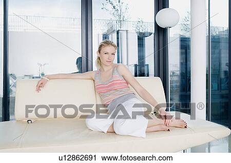 Stock Image - Woman on a sofa.. Fotosearch