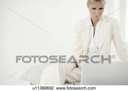 Woman with laptop on bed. View Large Photo Image Stock Image - Woman with laptop on bed.. Fotosearch